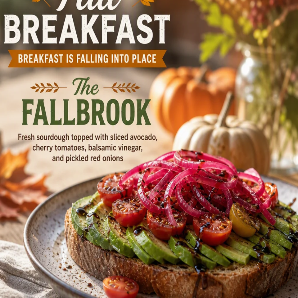Fallbrook avocado toast on sourdough topped with cherry tomatoes, balsamic glaze, and pickled red onions, surrounded by pumpkins.
