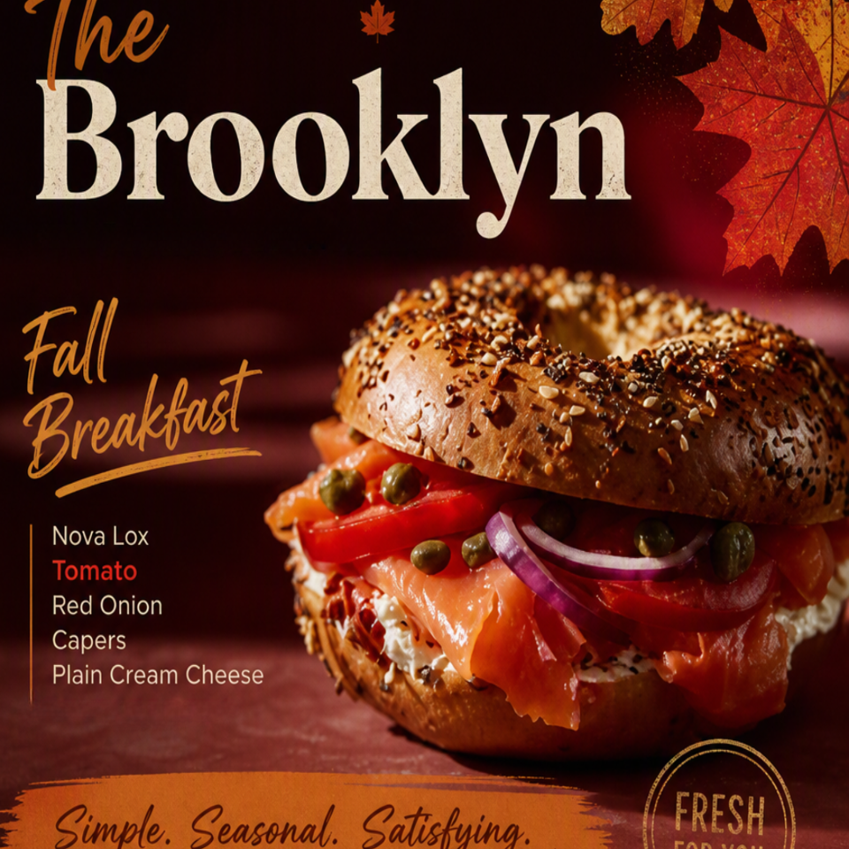 Fall-themed Brooklyn breakfast sandwich with nova lox, tomato, red onion, capers, and cream cheese on a seeded bagel.